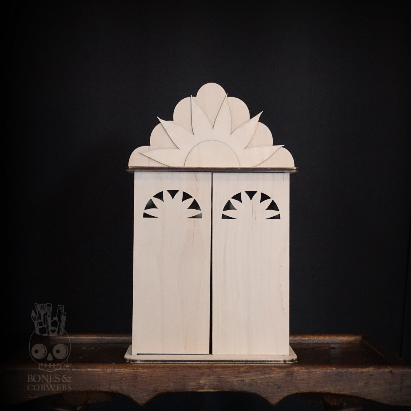 Wooden nicho with doors close. Intricate design on a dark background. 