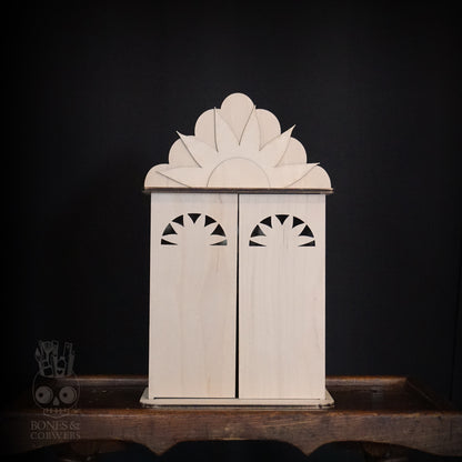 Wooden nicho with doors close. Intricate design on a dark background. 