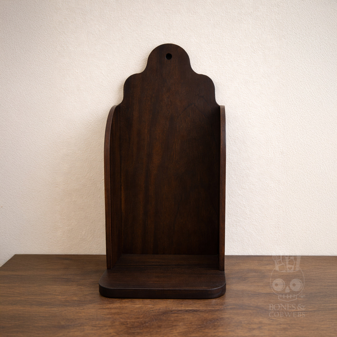 Wooden altar on a wooden surface with a plain background. Example of espresso stain.