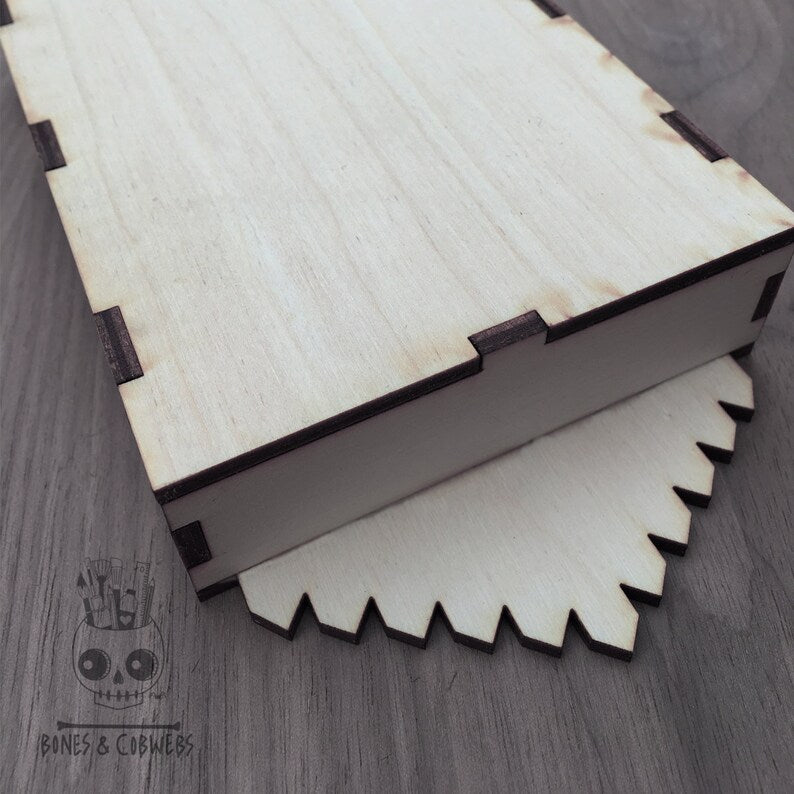 The back of the wooden shadow box on a tabletop.