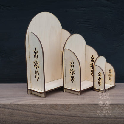 Set of wooden decorative arches with floral patterns on a dark background